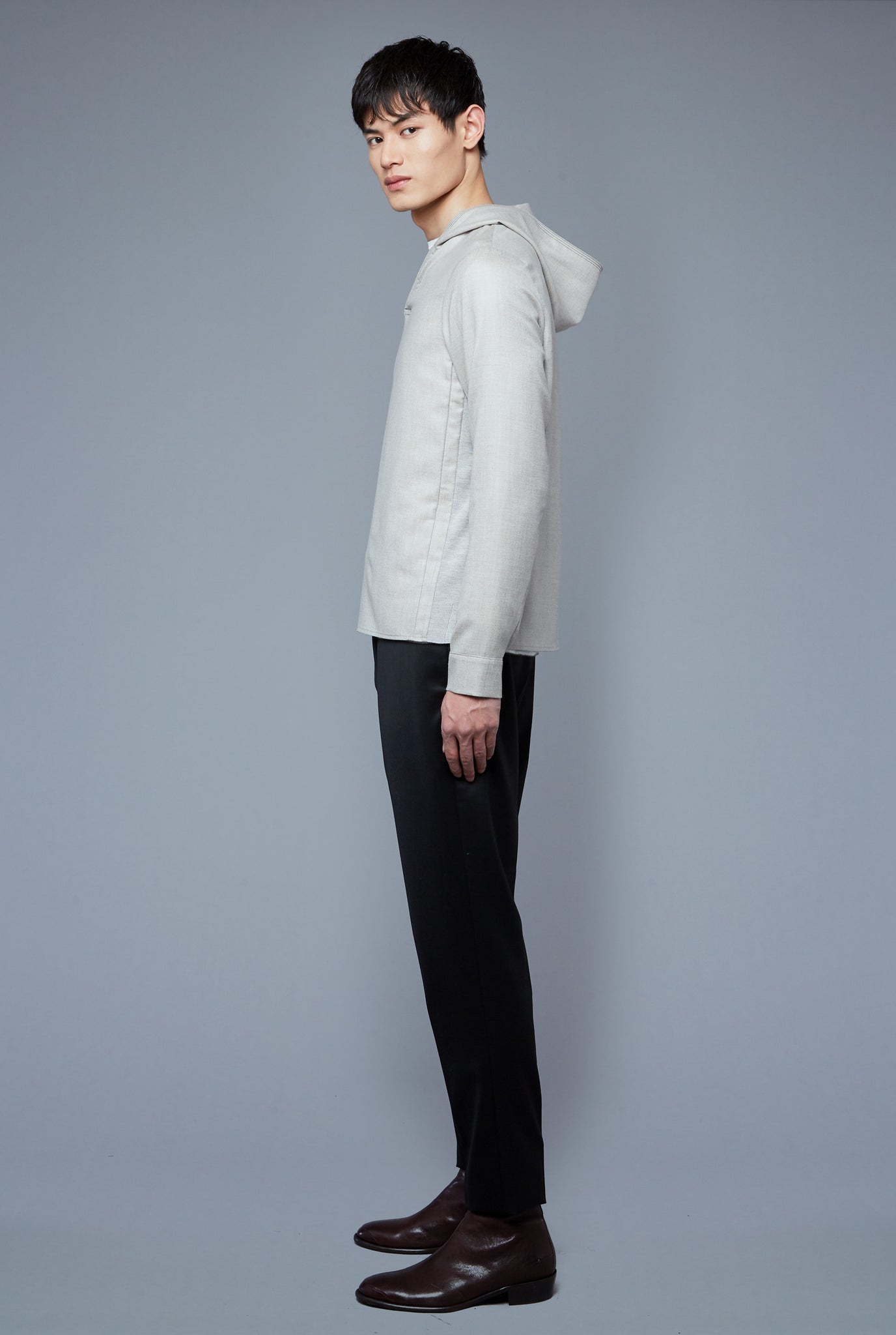 Side View: Model Qiang Li wearing Woven Hoodie