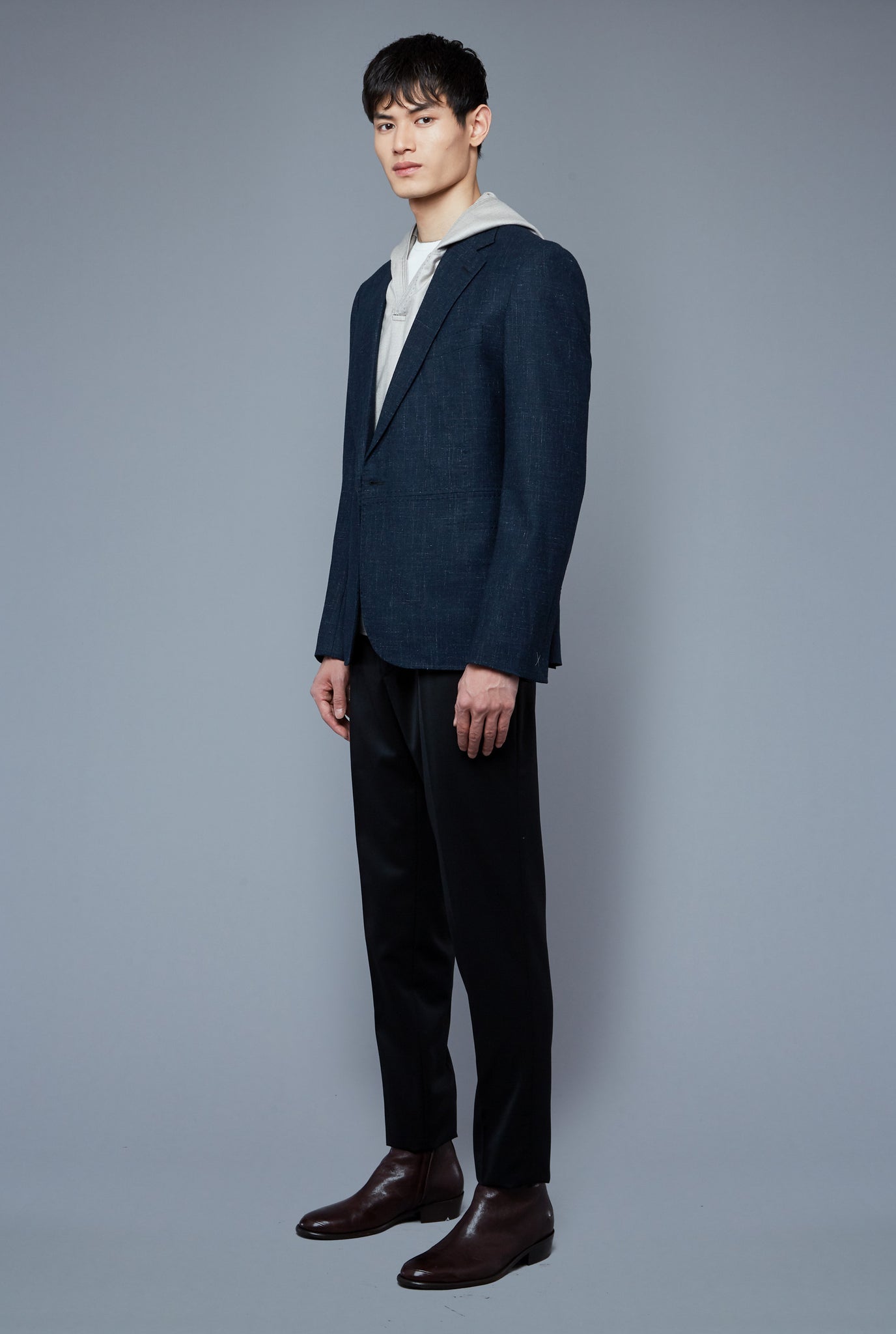 Three Quarter Layer View: Model Qiang Li wearing Woven Hoodie