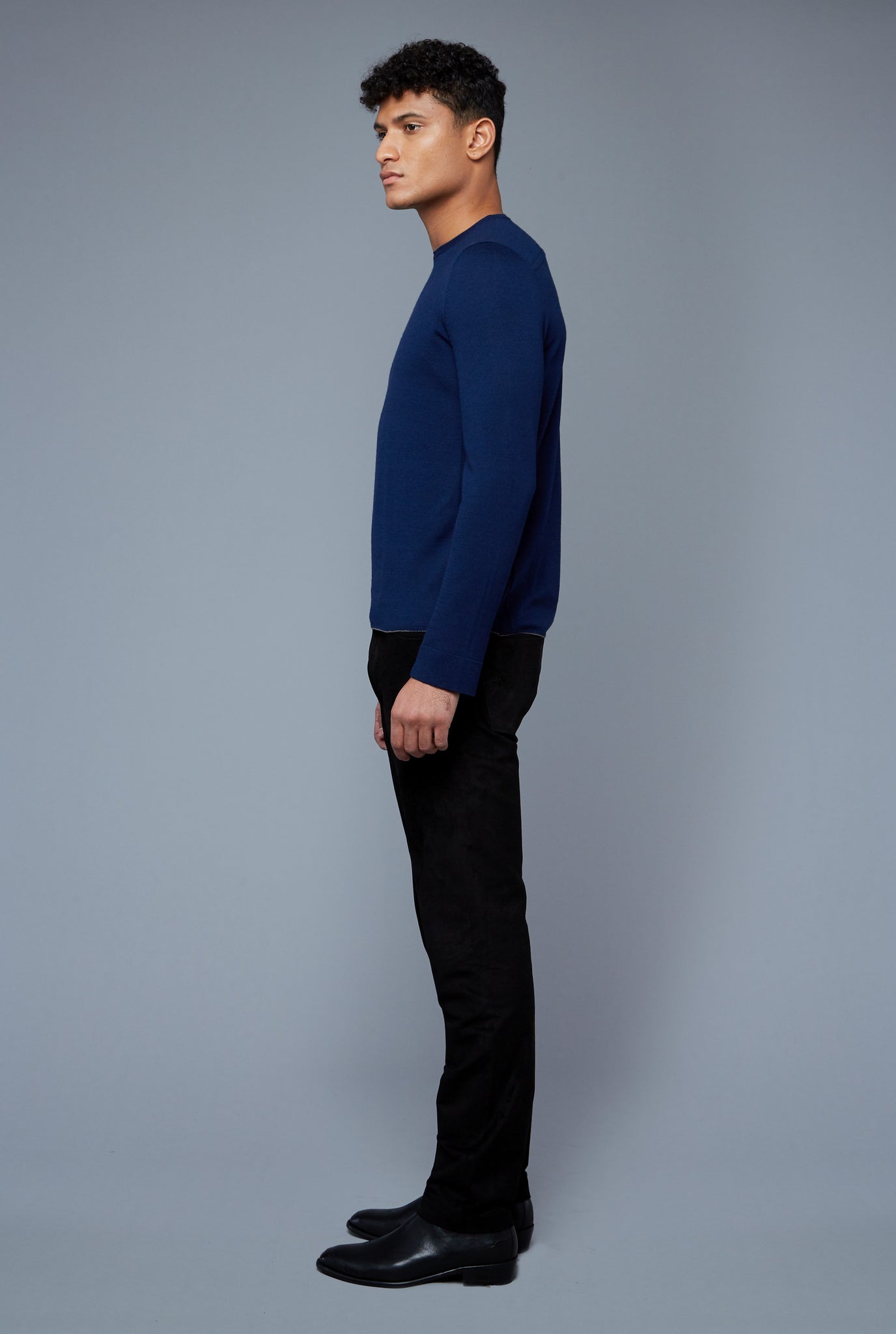 Side View: Model Tre Boutilier wearing Long Sleeve Sweater Tee