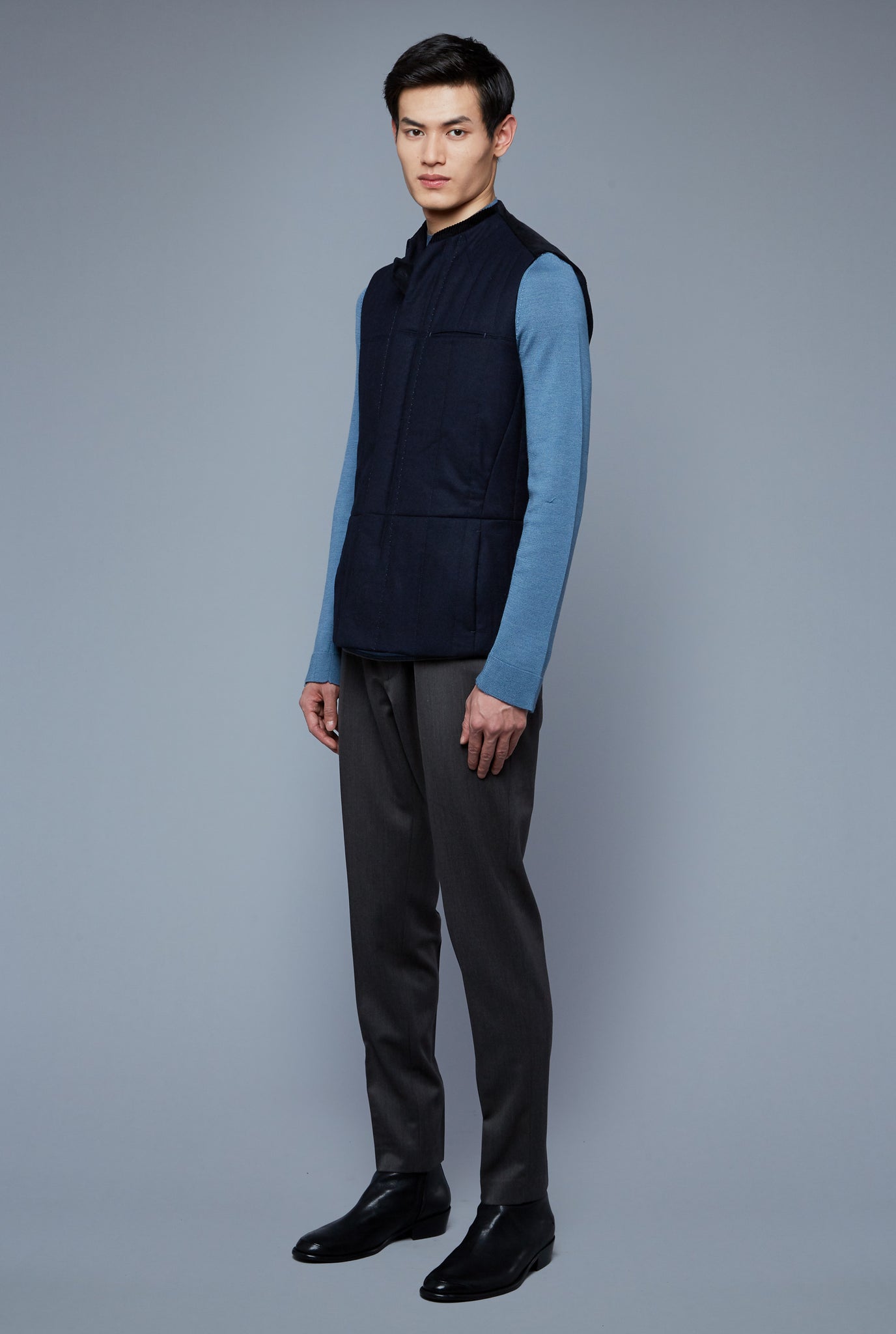 Three Quarter View: Model Qiang Li wearing Down Vest
