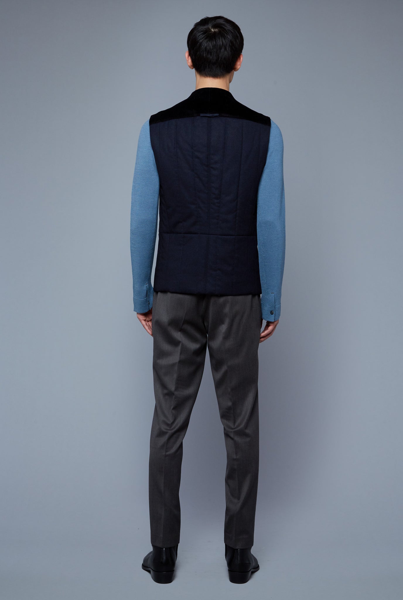 Back View: Model Qiang Li wearing Down Vest