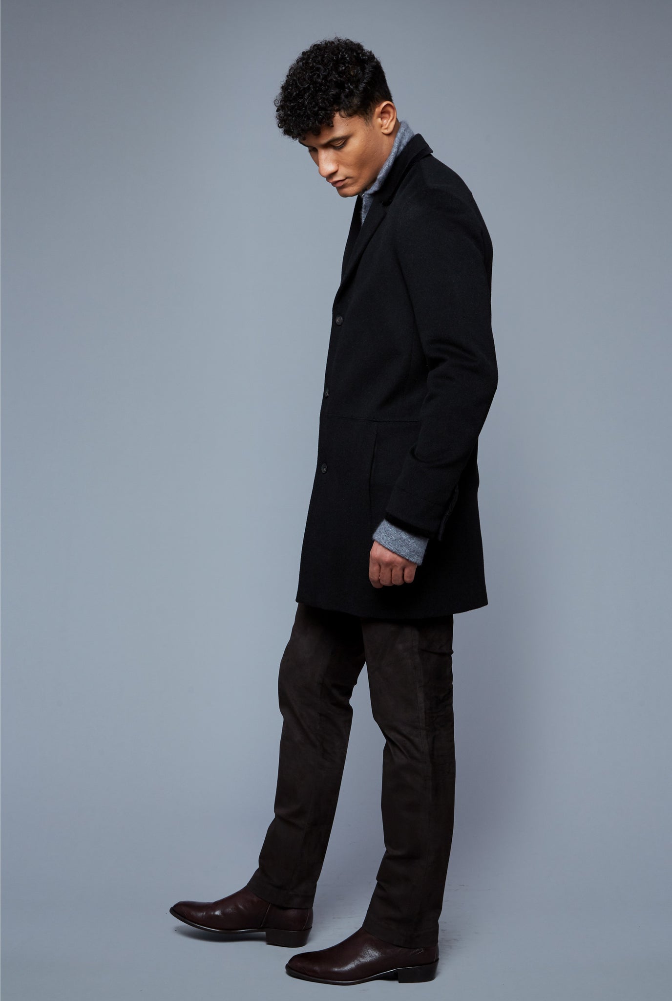 Side View: Model Tre Boutilier wearing Camel Coat