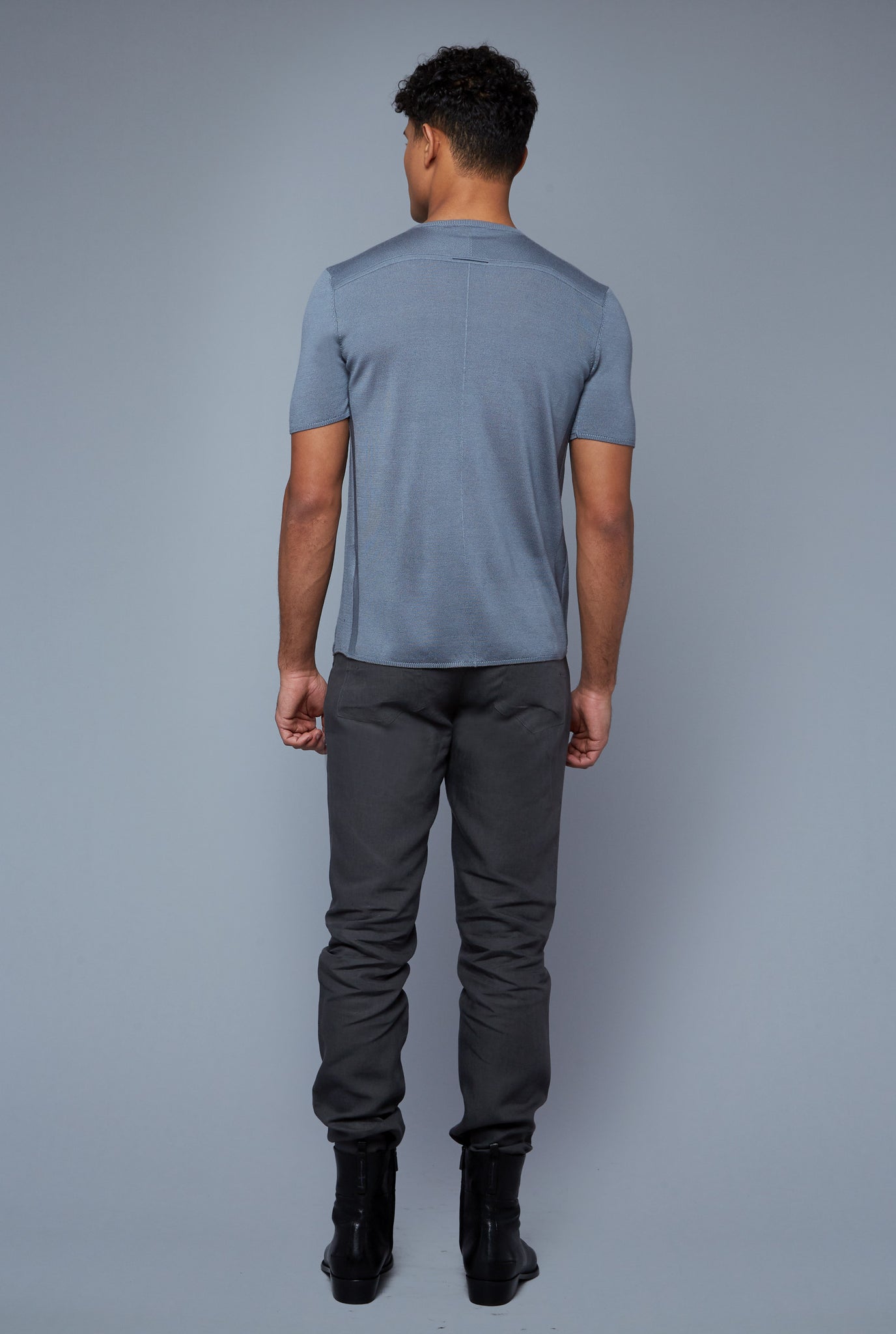 Back View: Model Tre Boutilier wearing Short Sleeve Sweater Tee
