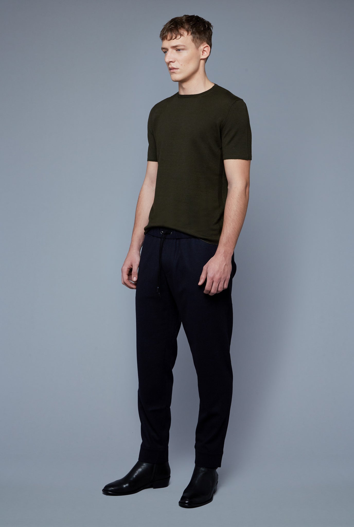 Three Quarter View: Model Milos Drago wearing Short Sleeve Sweater Tee