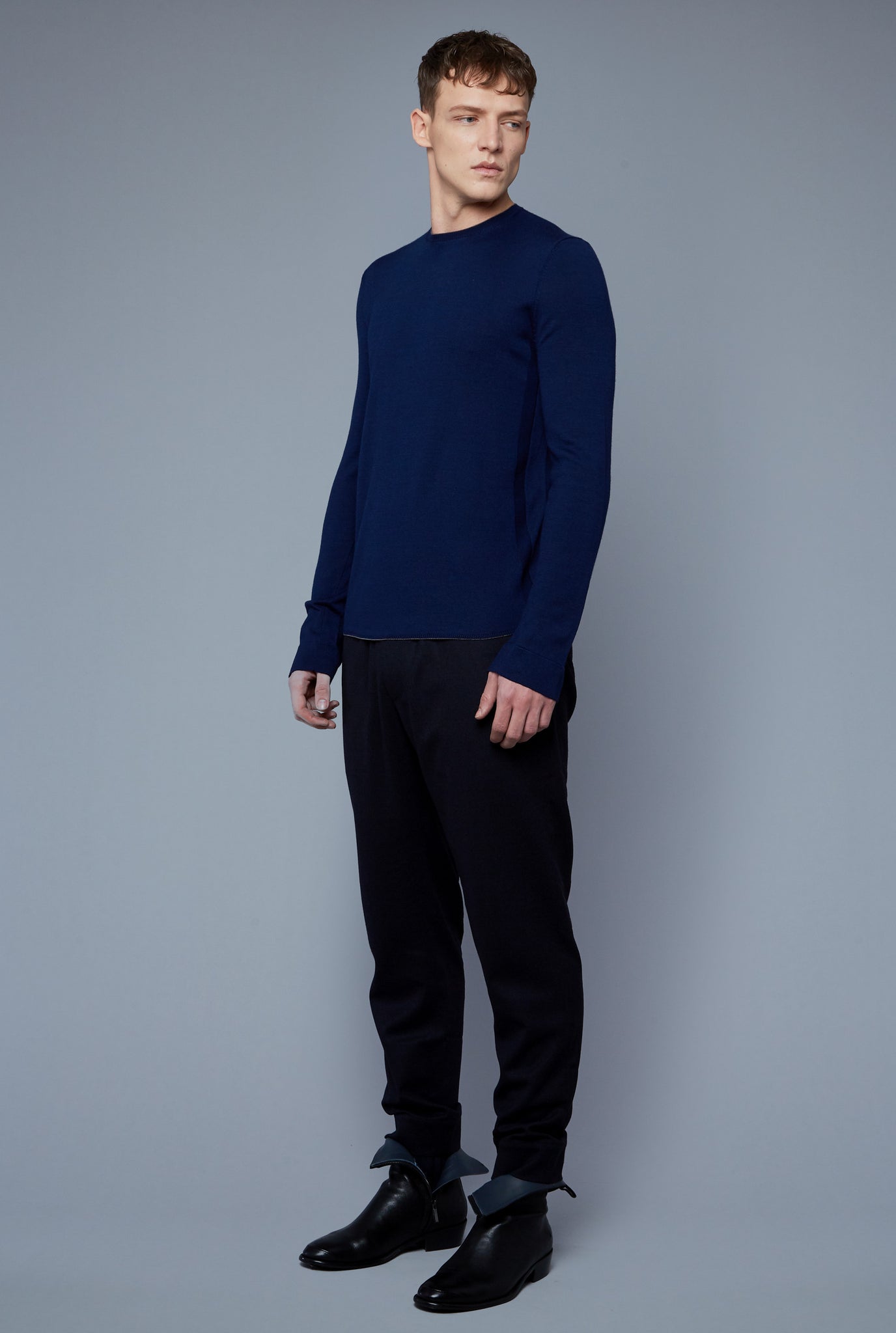 Three Quarter View: Model Milos Drago wearing Long Sleeve Sweater Tee