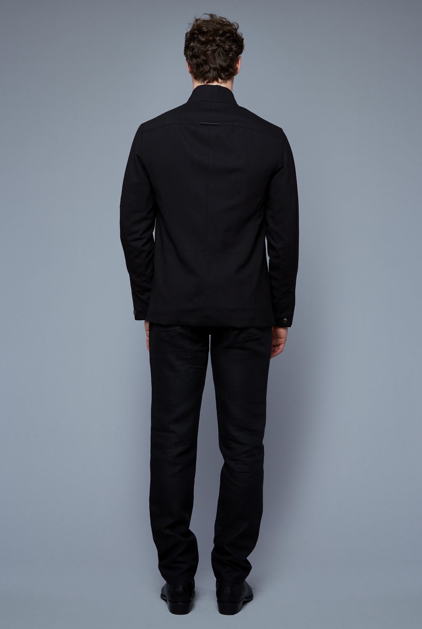 Back View: Model Hans Weiner wearing Seasonless Bomber