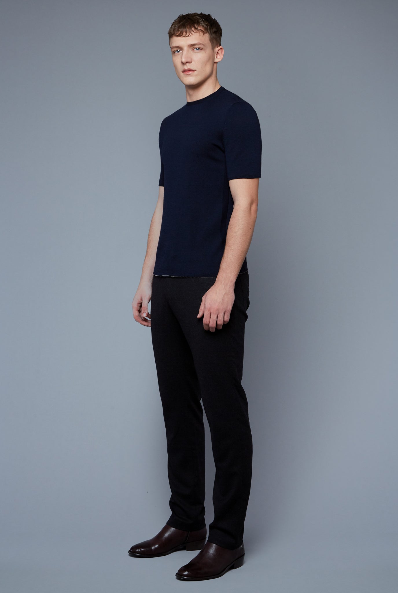 Three Quarter View: Model Milos Drago wearing Short Sleeve Sweater Tee