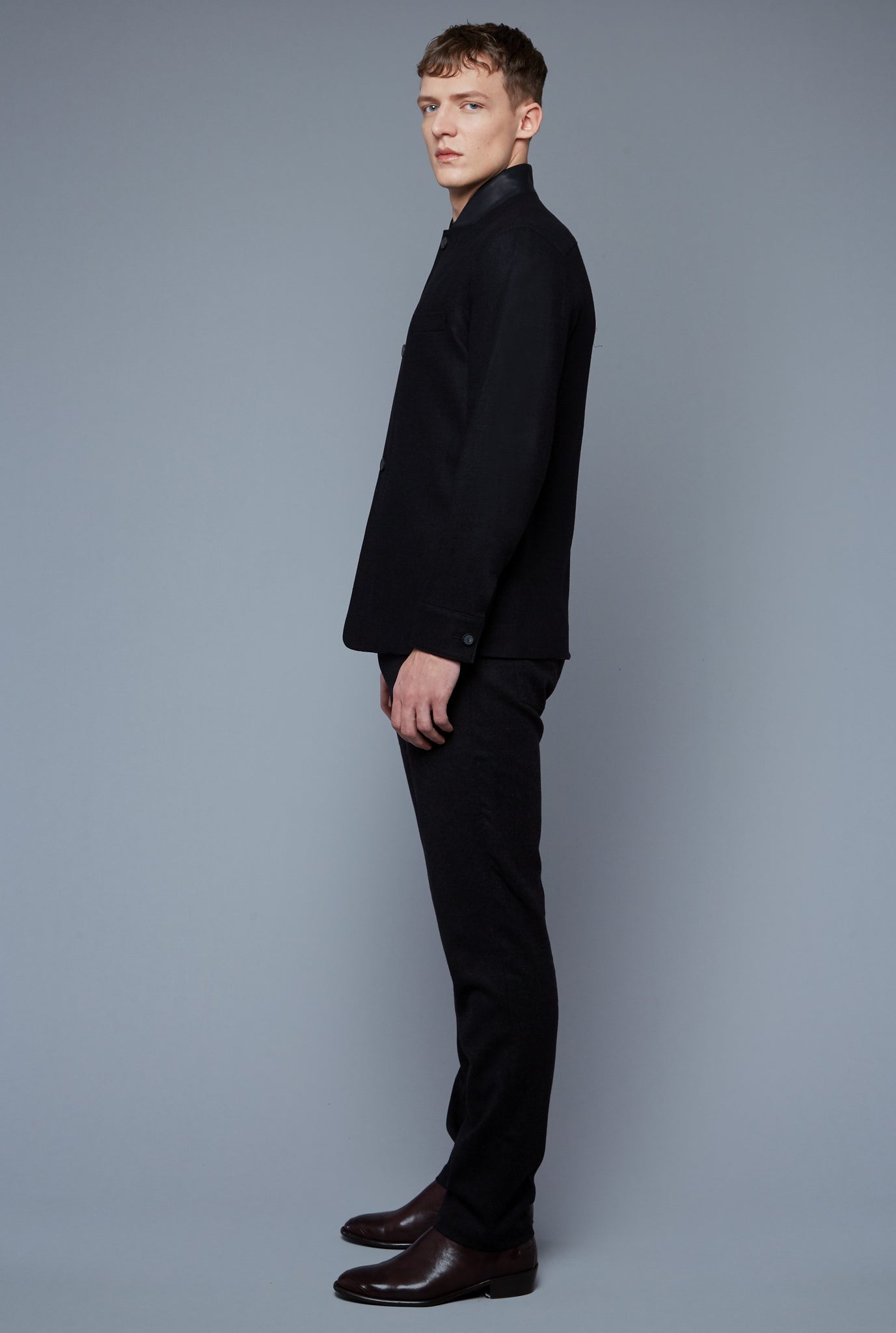 Side View: Model Milos Drago wearing Compass Jacket