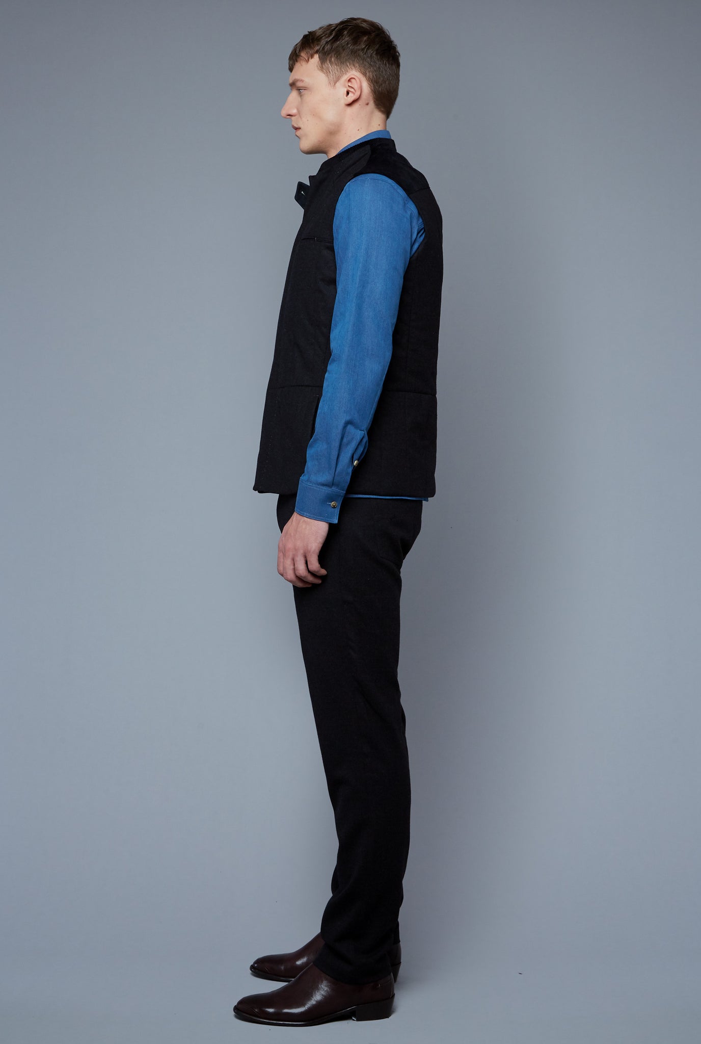 Side View: Model Milos Drago wearing Down Vest