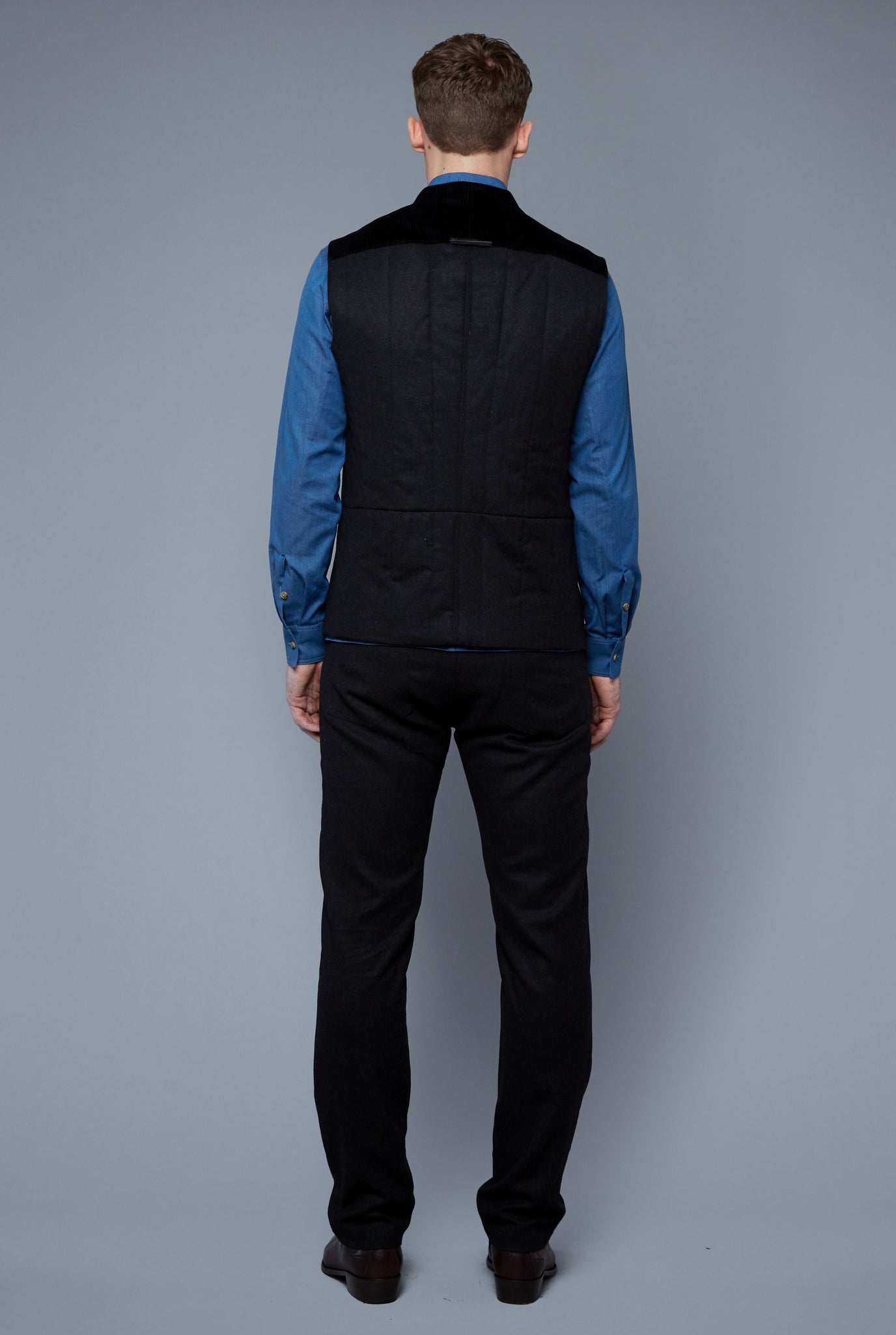 Back View: Model Milos Drago wearing Down Vest