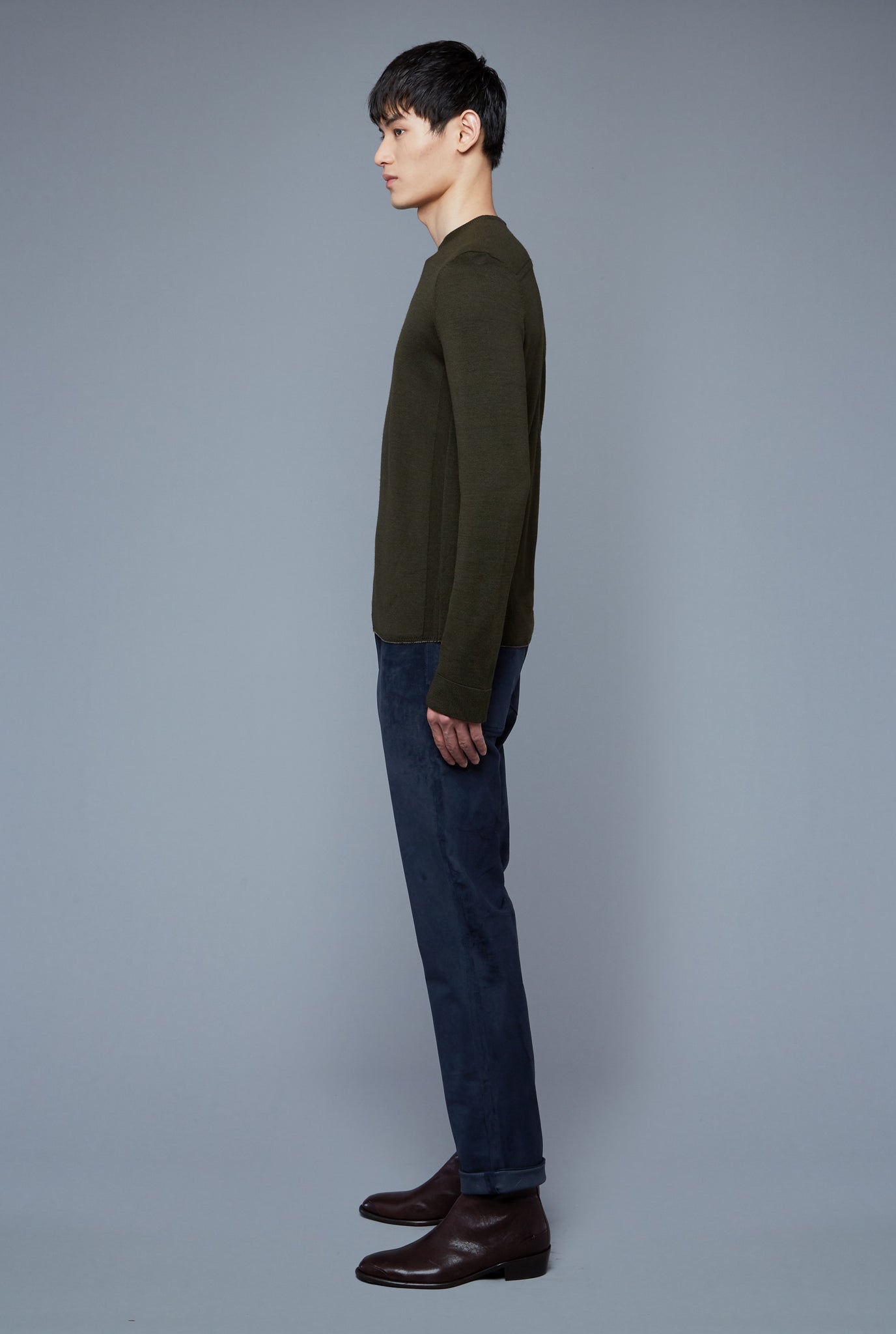 Side View: Model Qiang Li wearing Long Sleeve Sweater Tee