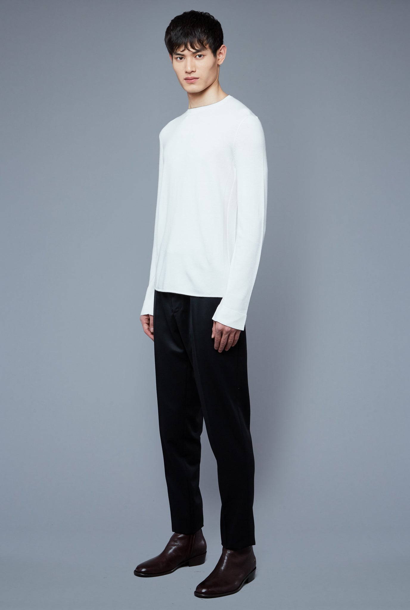 Three Quarter View: Model Qiang Li wearing Long Sleeve Sweater Tee