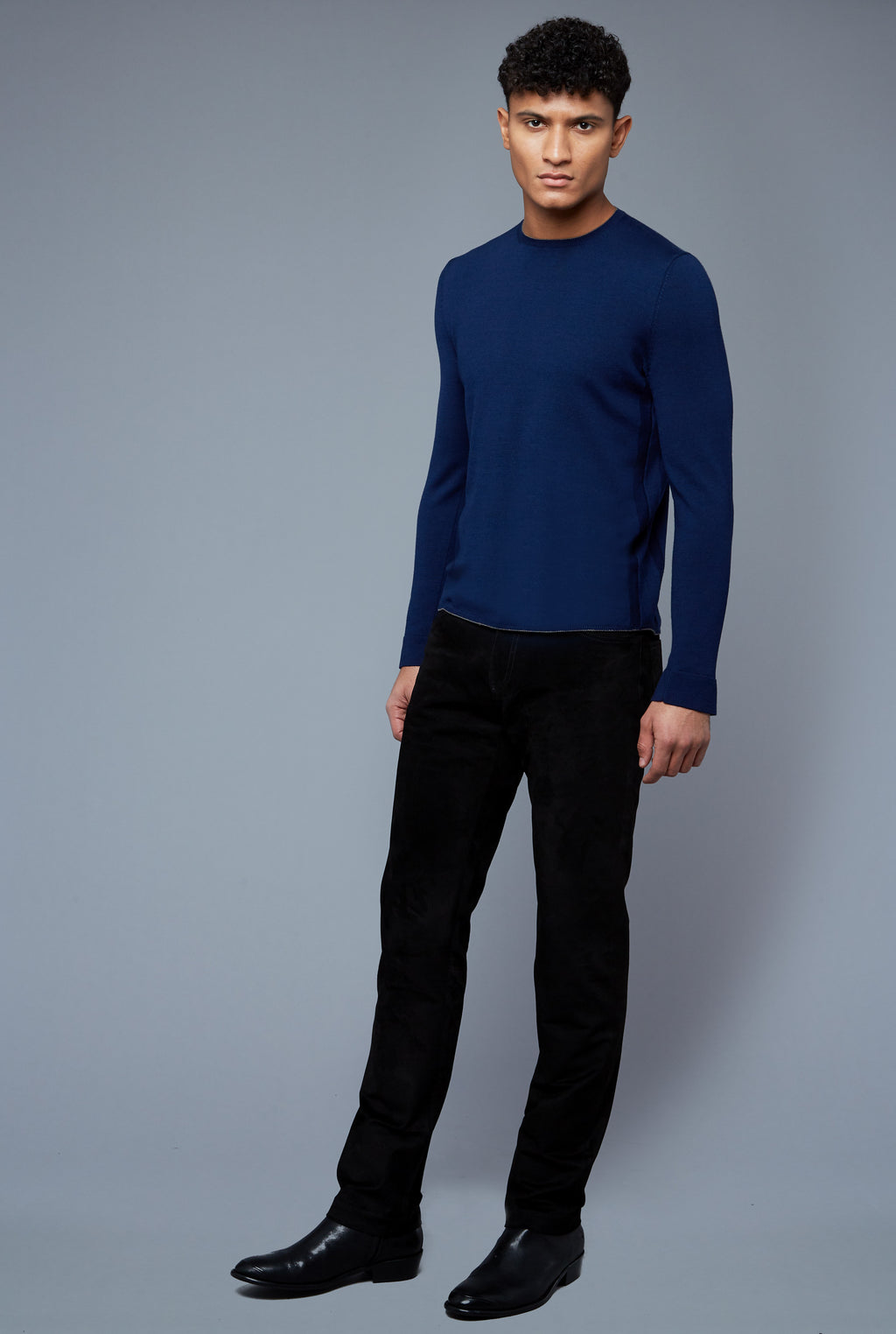 Three Quarter View: Model Tre Boutilier wearing Long Sleeve Sweater Tee