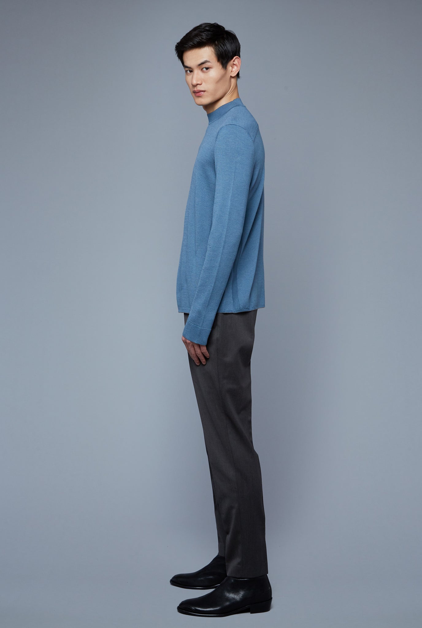 Side View: Model Qiang Li wearing Royal Neck Sweater Tee