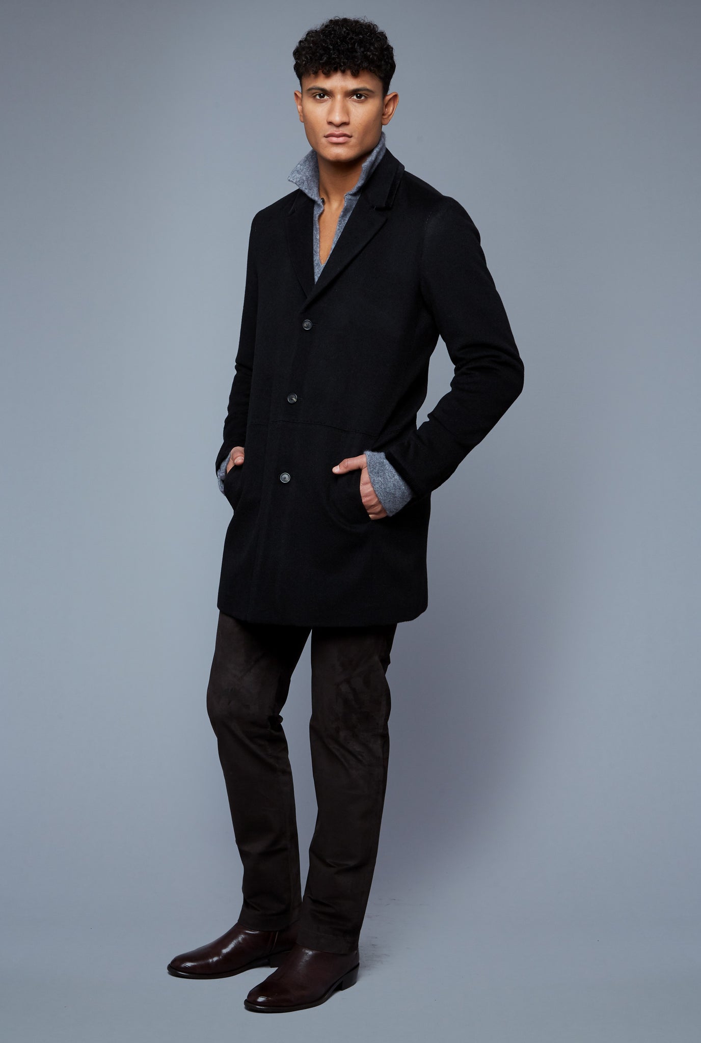 Three Quarter View: Model Tre Boutilier wearing Camel Coat
