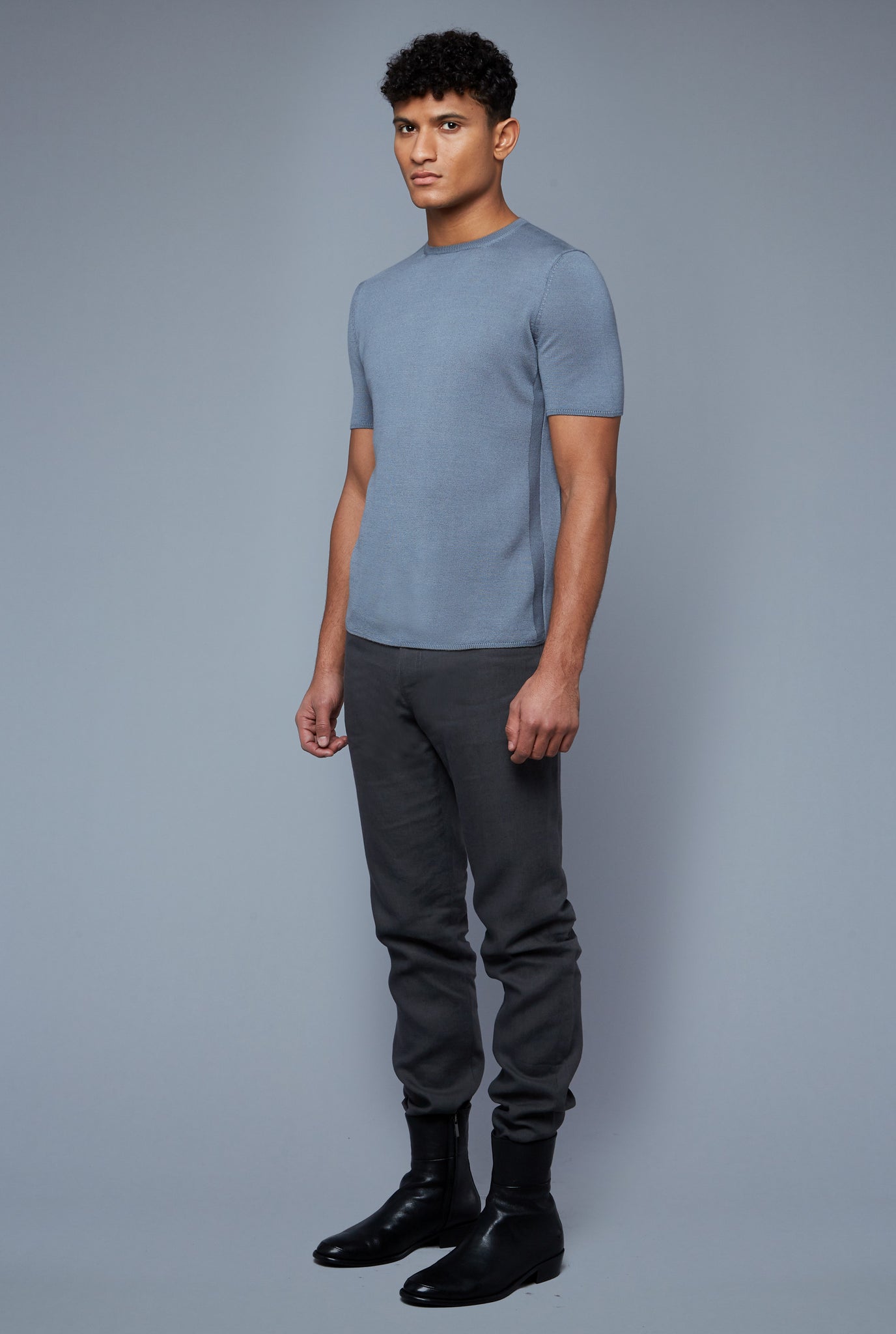Three Quarter View: Model Tre Boutilier wearing Short Sleeve Sweater Tee